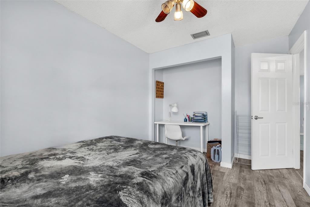 128 Euclid Avenue Seffner, FL 33584 - Photo 17 of 38 a bedroom with a bed and a chandelier