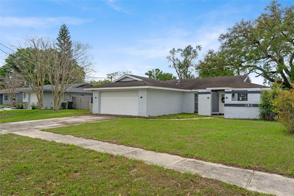 128 Euclid Avenue Seffner, FL 33584 - Photo 2 of 38 front view of a house with a yard