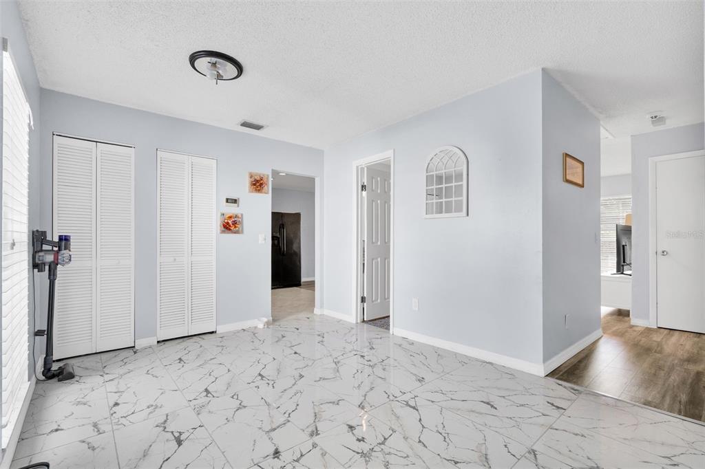 128 Euclid Avenue Seffner, FL 33584 - Photo 5 of 38 a view of a livingroom with wooden floor and a bathroom