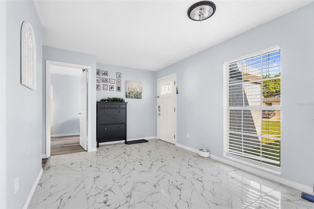 128 Euclid Avenue Seffner, FL 33584 - Photo 6 of 38 a view of a livingroom with wooden floor and a window