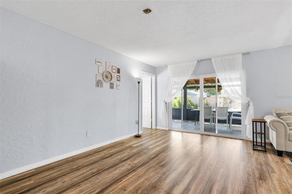128 Euclid Avenue Seffner, FL 33584 - Photo 9 of 38 wooden floor in an empty room with a window