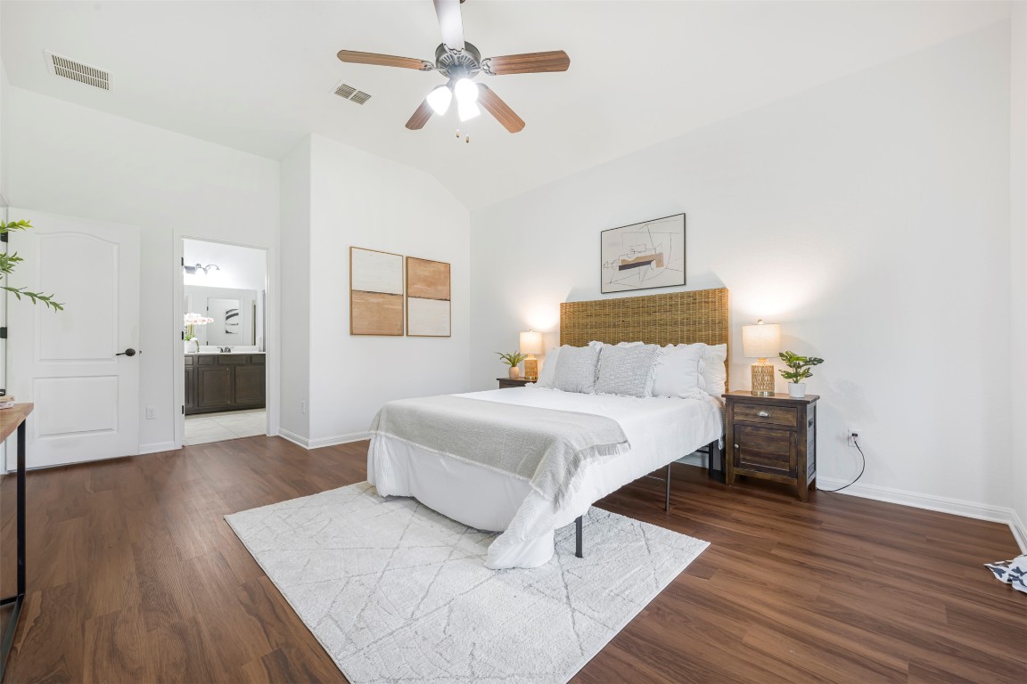 1812 Hidden Springs Path Round Rock, TX 78665 - Photo 18 of 39 a bedroom with a bed and wooden floor