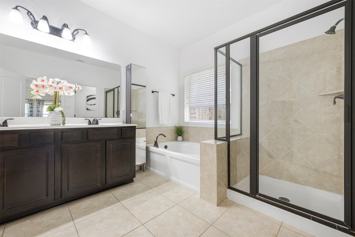 1812 Hidden Springs Path Round Rock, TX 78665 - Photo 20 of 39 a bathroom with a double vanity sink mirror and shower