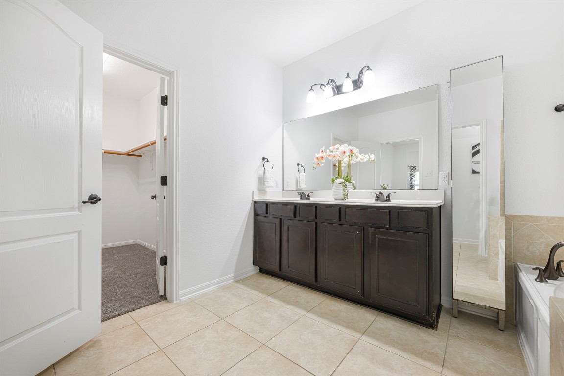 1812 Hidden Springs Path Round Rock, TX 78665 - Photo 22 of 39 a bathroom with a sink vanity and a mirror