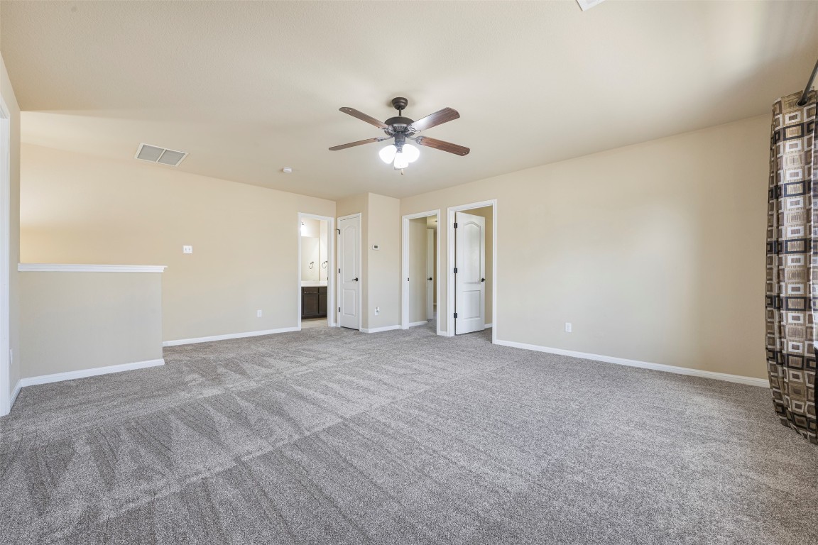 1812 Hidden Springs Path Round Rock, TX 78665 - Photo 27 of 39 a view of a big room with a ceiling fan and a window
