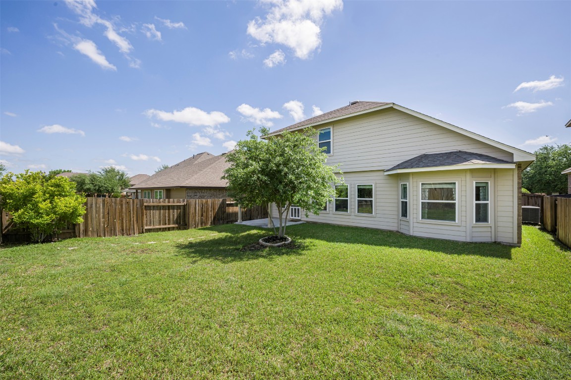 1812 Hidden Springs Path Round Rock, TX 78665 - Photo 39 of 39 a backyard of a house with table and chairs
