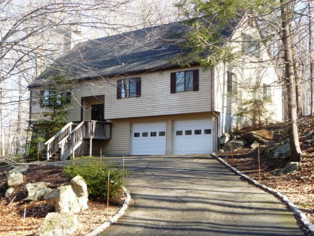 83 Scodon Drive Ridgefield, CT 06877 - Photo 1 of 1 a front view of a house with garden