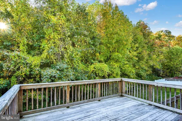 a balcony with wooden floor and fence