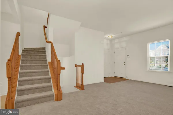 a view of an empty room with stairs