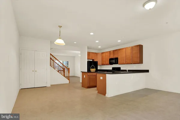 a kitchen with stainless steel appliances a stove top oven a sink and a refrigerator