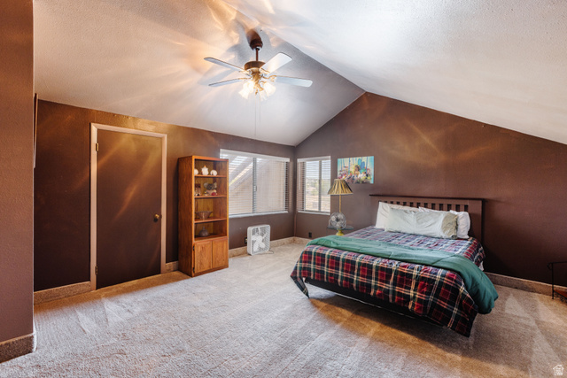1470 Redwood Tree Street St. George, UT 84790 - Photo 29 of 53 Room featuring a vaulted ceiling with a ceiling fan, recessed windows with blinds, and light-colored carpeting
