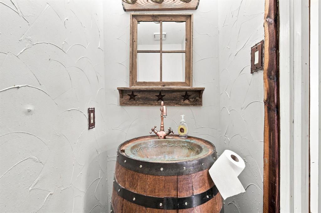 9732 Timber Trail Scurry, TX 75158 - Photo 18 of 39 powder room by living room showcasing barrel sink