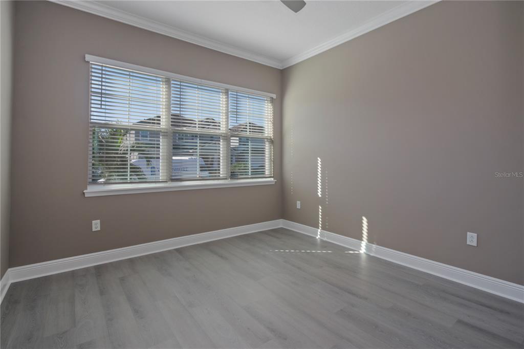 1427 Lake Florence Way Winter Park, FL 32792 - Photo 12 of 32 a view of an empty room with wooden floor and a window