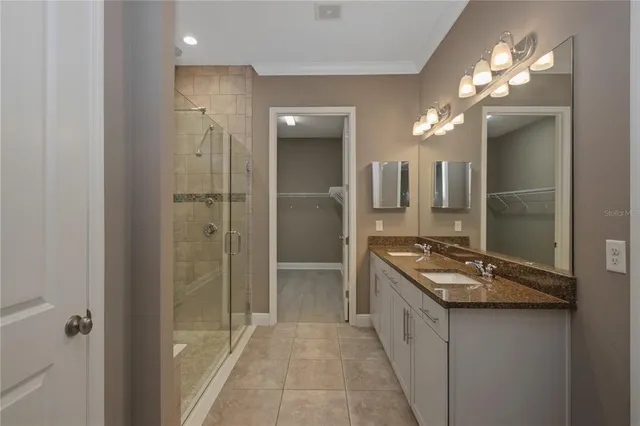 a bathroom with a sink a mirror and a shower