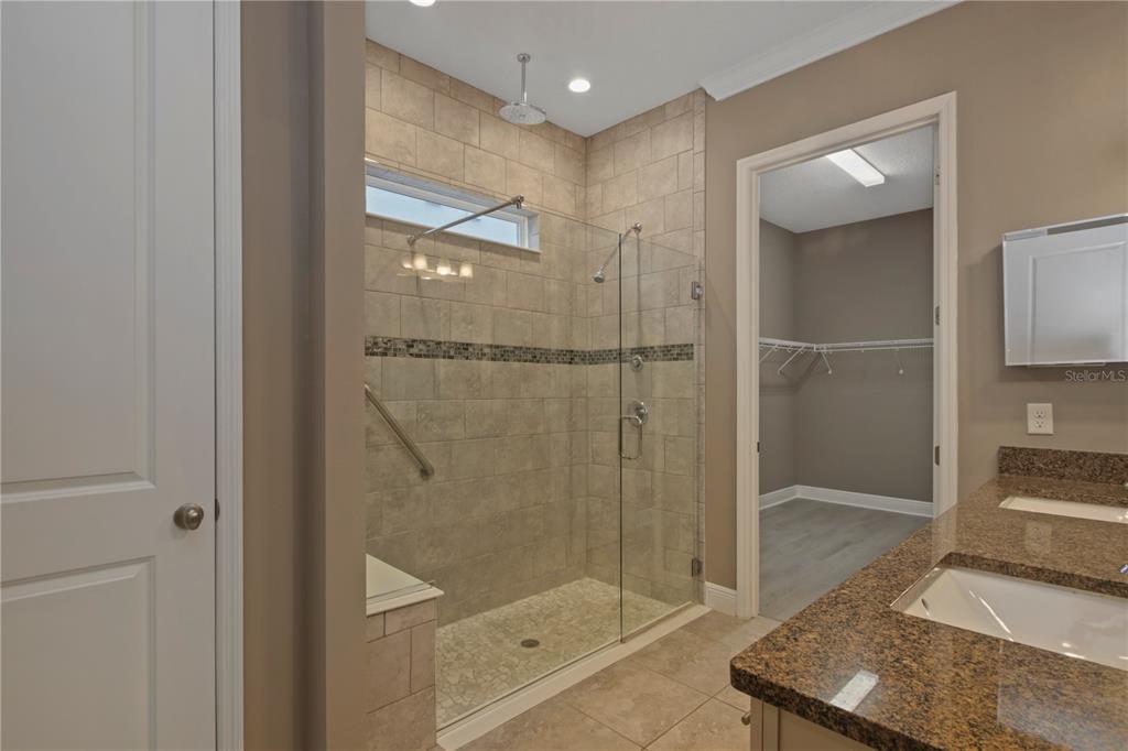 1427 Lake Florence Way Winter Park, FL 32792 - Photo 17 of 32 a bathroom with a shower a mirror and a sink