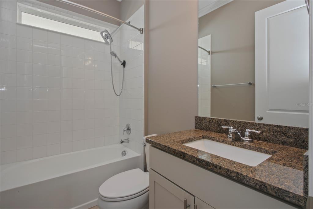 1427 Lake Florence Way Winter Park, FL 32792 - Photo 27 of 32 a bathroom with a granite countertop sink toilet and shower