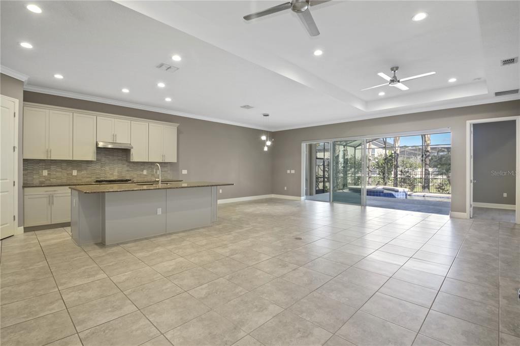 1427 Lake Florence Way Winter Park, FL 32792 - Photo 3 of 32 a large kitchen with stainless steel appliances granite countertop a large counter top and a stove top oven with wooden floor