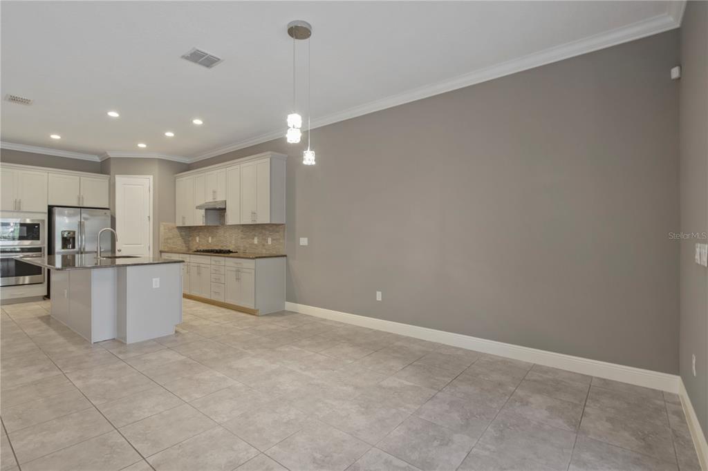 1427 Lake Florence Way Winter Park, FL 32792 - Photo 6 of 32 a kitchen with a refrigerator and a stove top oven