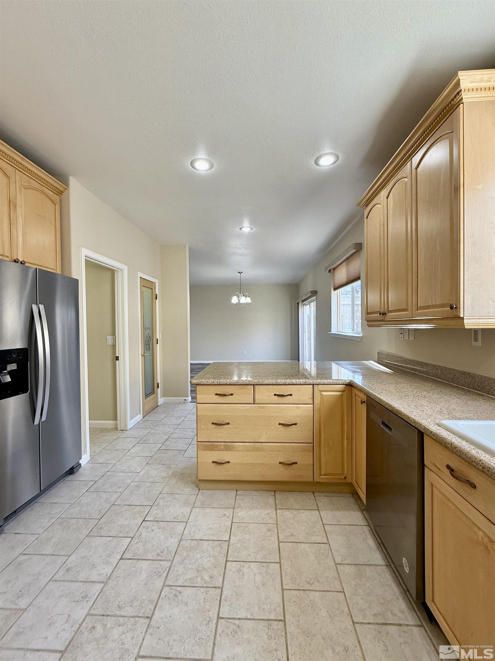 1090 Spring Drive Carson City, NV 89703 - Photo 11 of 31 a large kitchen with stainless steel appliances granite countertop a refrigerator and a stove top oven