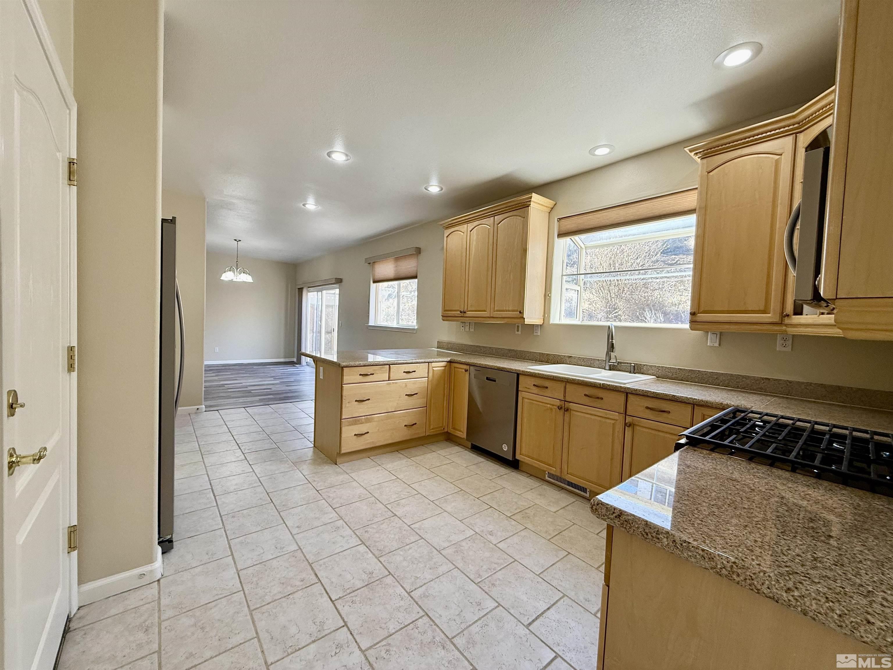1090 Spring Drive Carson City, NV 89703 - Photo 12 of 31 a kitchen with stainless steel appliances granite countertop a sink and cabinets