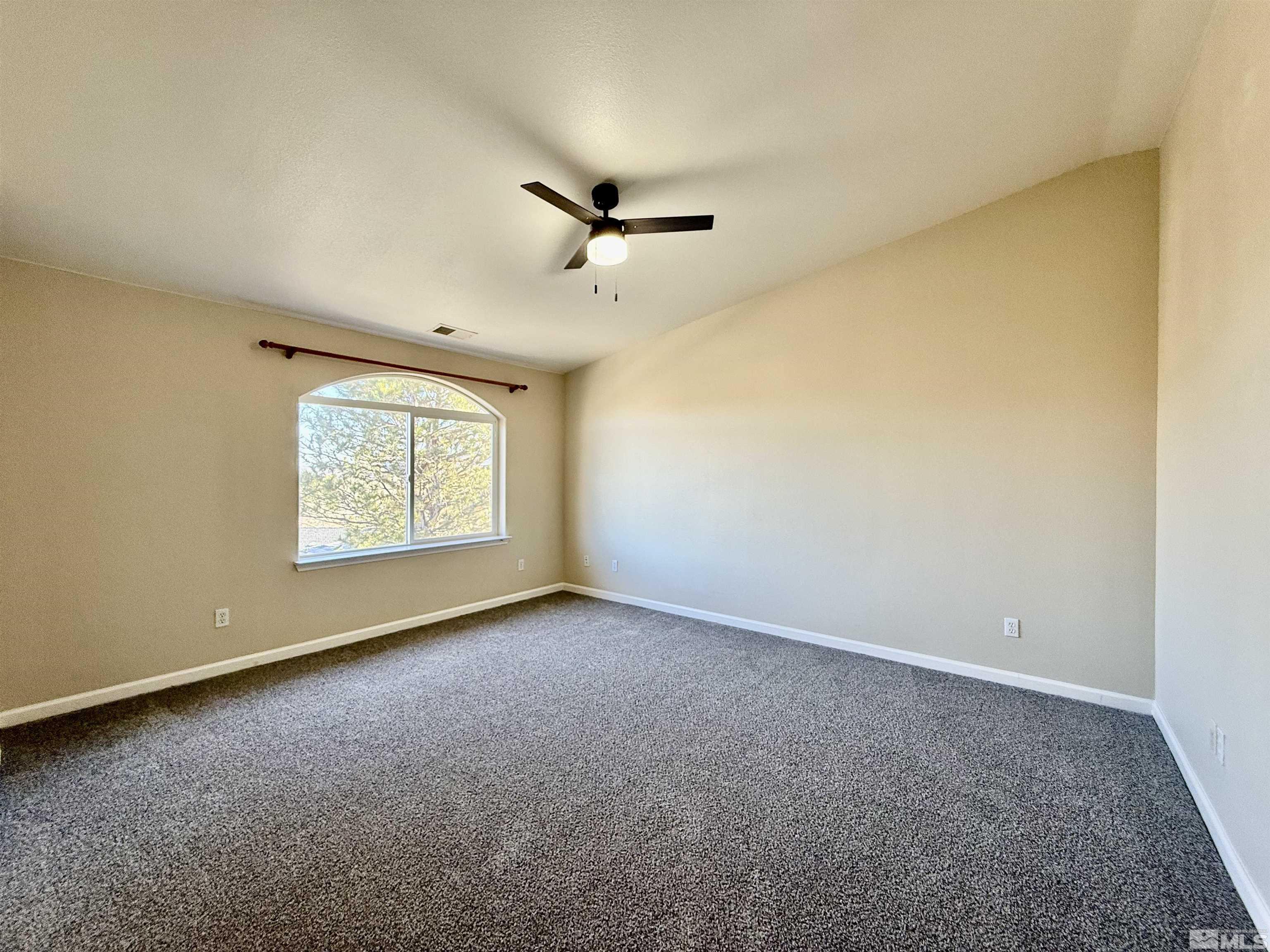 1090 Spring Drive Carson City, NV 89703 - Photo 16 of 31 an empty room with a window and a ceiling fan