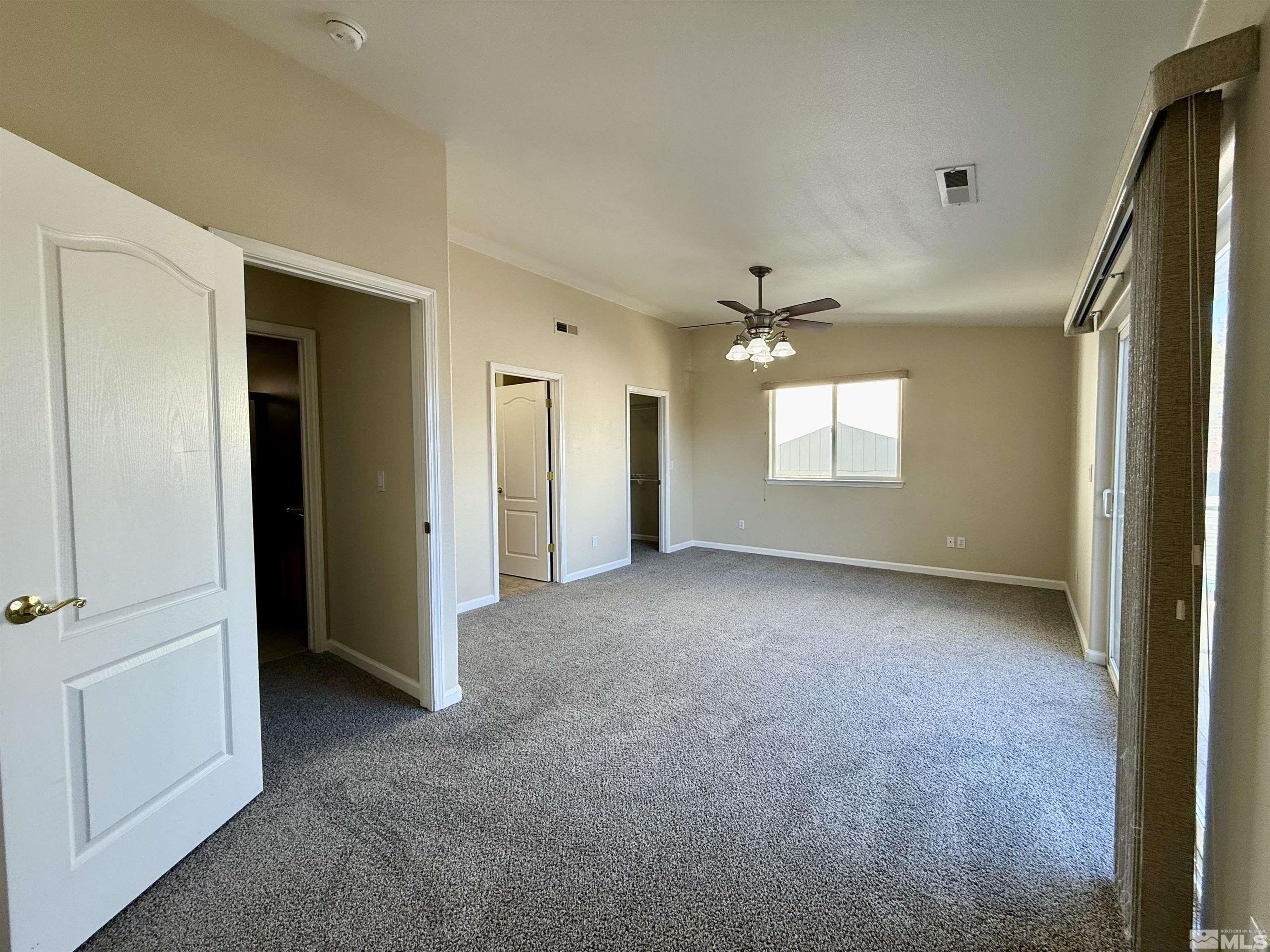 1090 Spring Drive Carson City, NV 89703 - Photo 20 of 31 a view of a big room with windows and chandelier fan