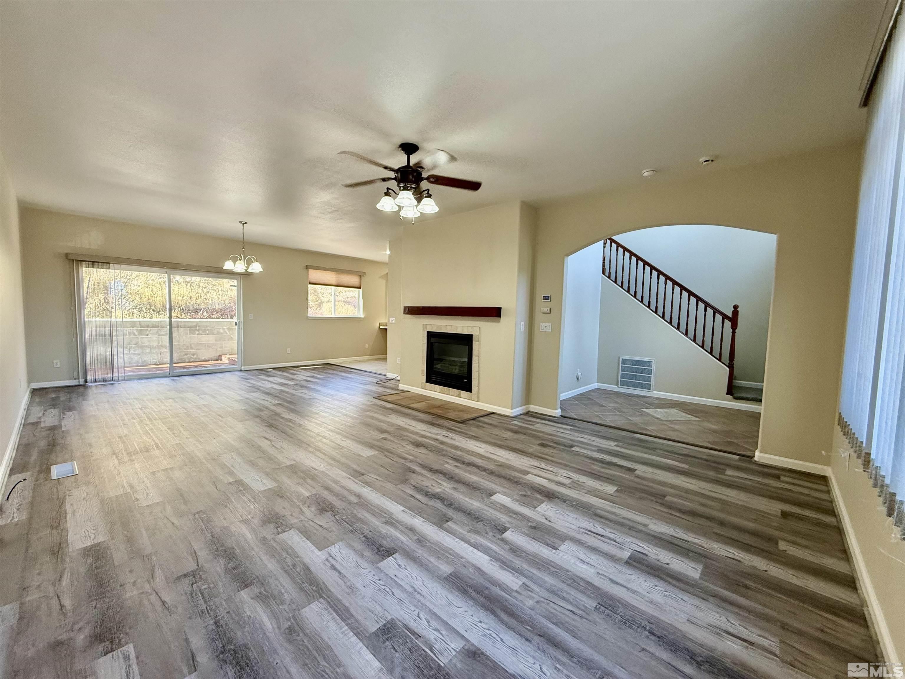 1090 Spring Drive Carson City, NV 89703 - Photo 3 of 31 wooden floor in an empty room with a fireplace