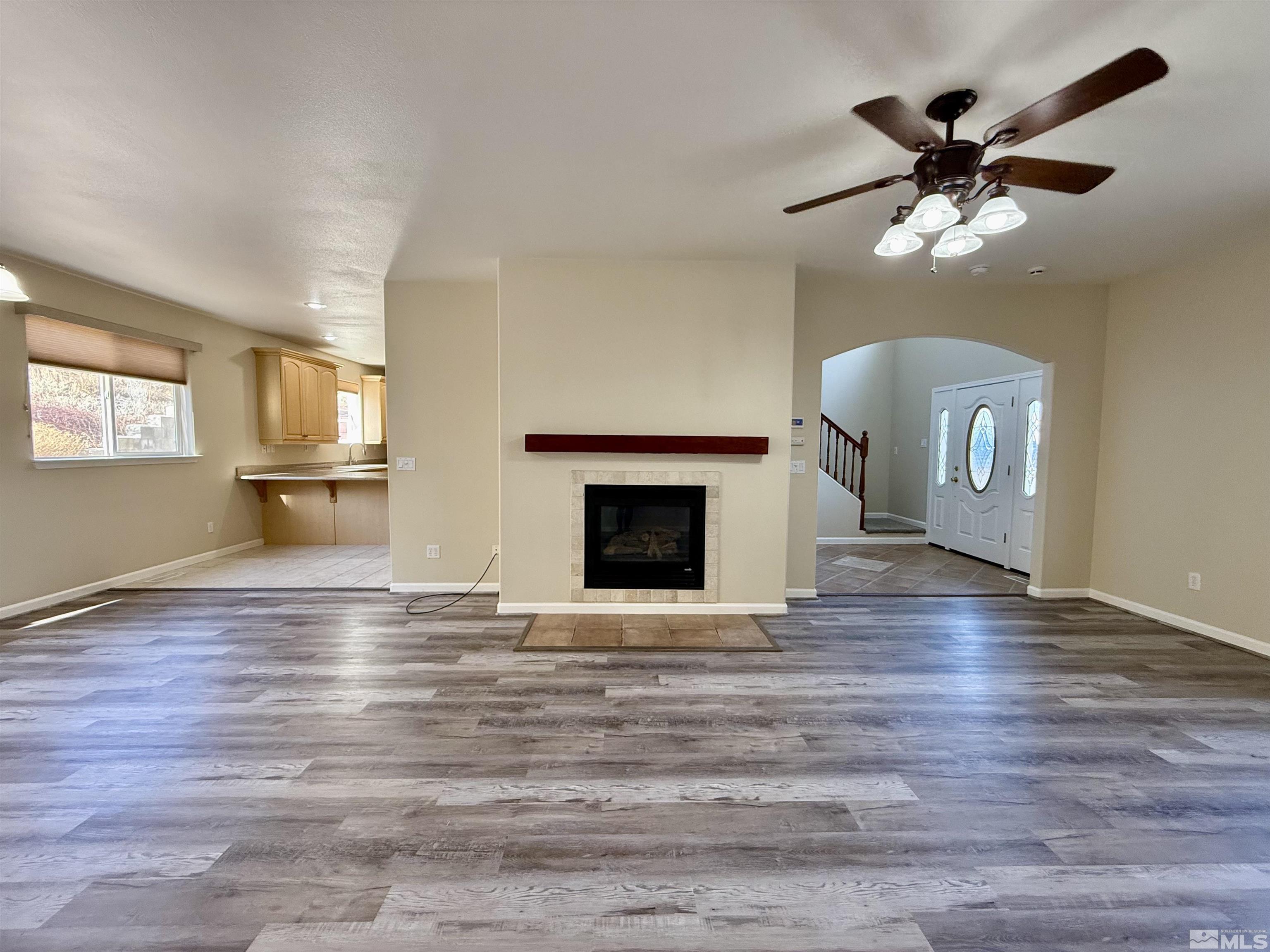 1090 Spring Drive Carson City, NV 89703 - Photo 4 of 31 a view of an empty room with a fireplace and a window
