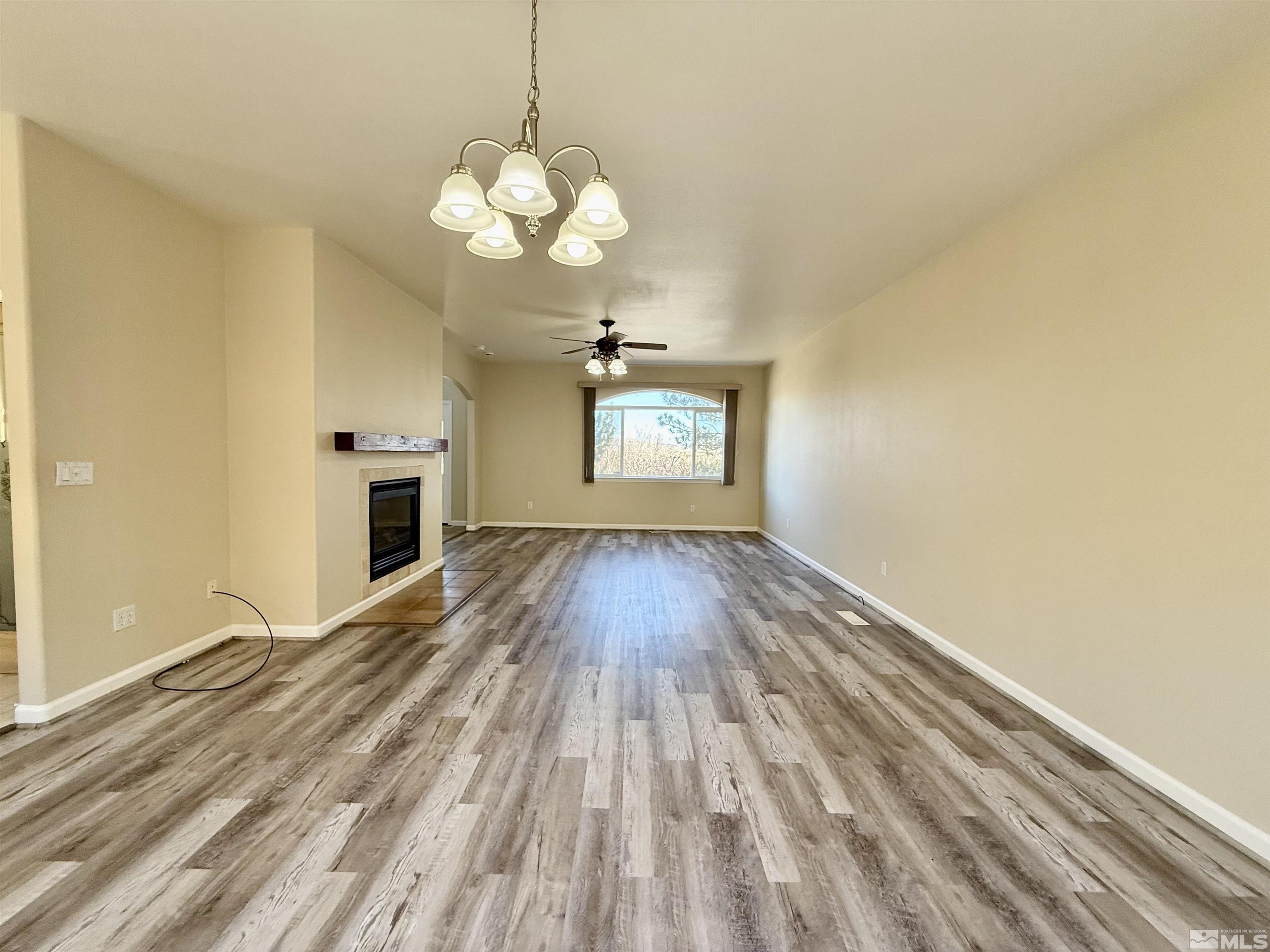 1090 Spring Drive Carson City, NV 89703 - Photo 6 of 31 a view of a room with wooden floor and a ceiling fan