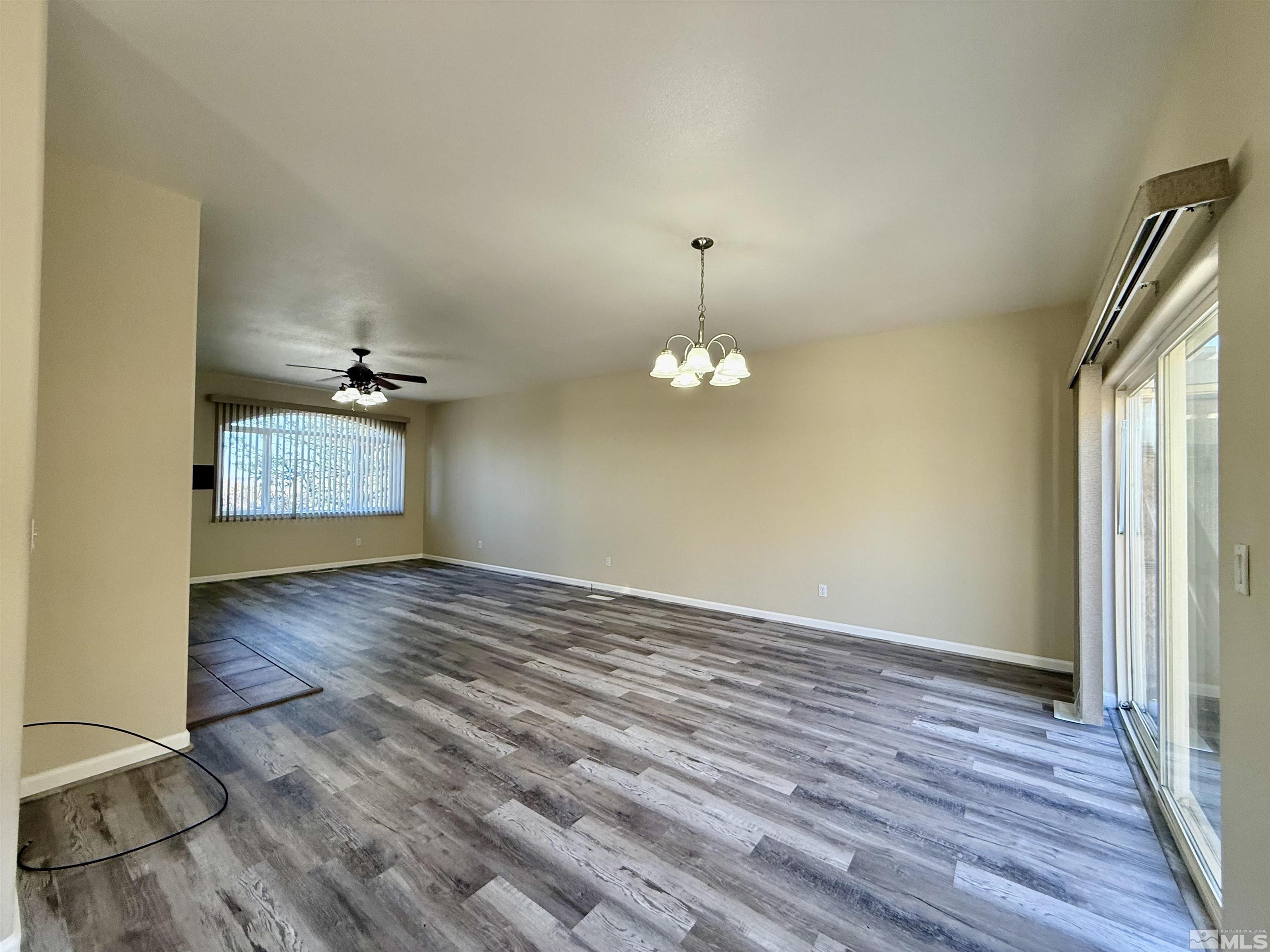 1090 Spring Drive Carson City, NV 89703 - Photo 7 of 31 wooden floor in an empty room with a window