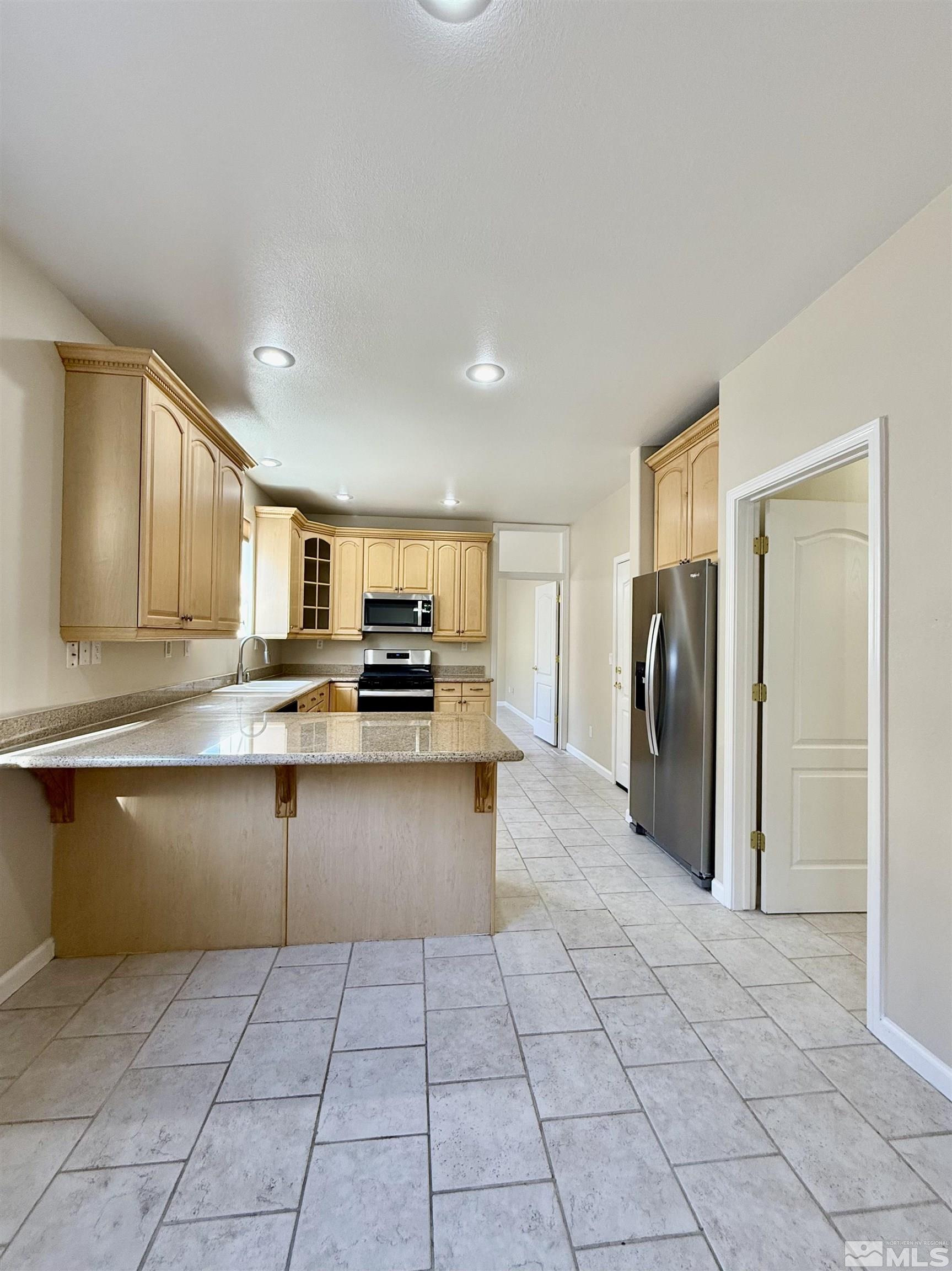 1090 Spring Drive Carson City, NV 89703 - Photo 8 of 31 a large kitchen with cabinets