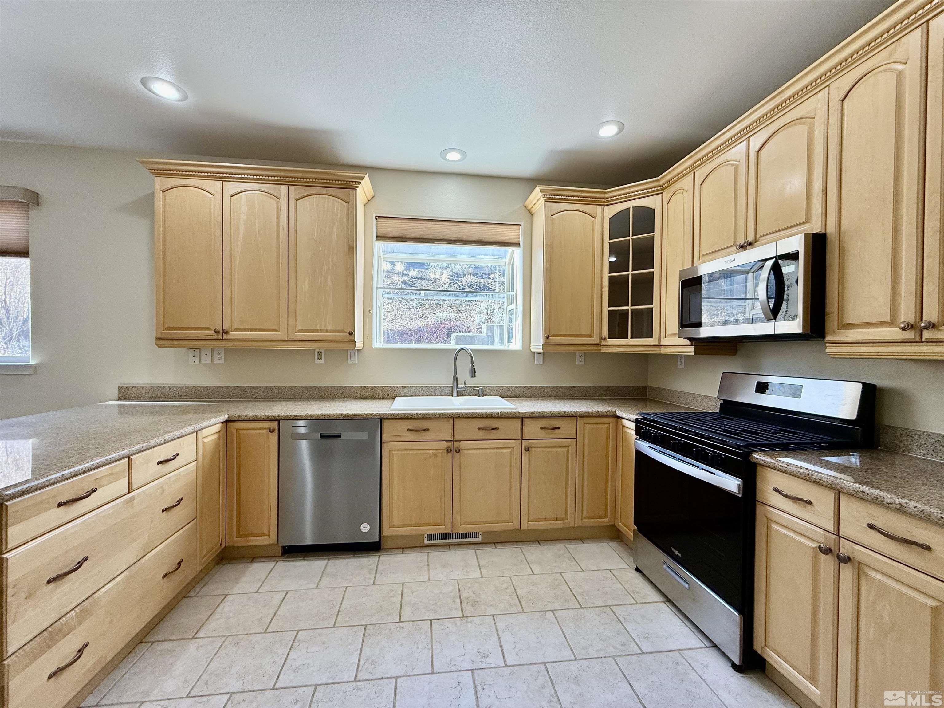 1090 Spring Drive Carson City, NV 89703 - Photo 10 of 31 a large kitchen with stainless steel appliances granite countertop a stove sink and cabinets
