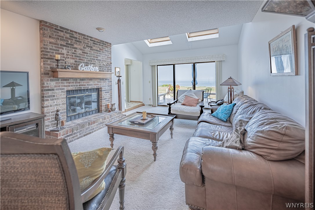 6071 East Lake Road, Unit 4 Newfane, NY 14028 - Photo 9 of 46 Living room with skylights and a fantastic lakevie