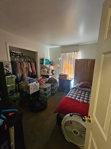 a bedroom with bed and wooden floor