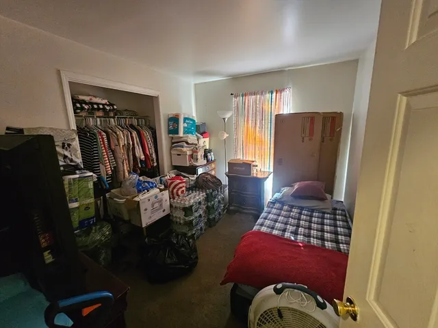 a view of a livingroom with furniture and closet