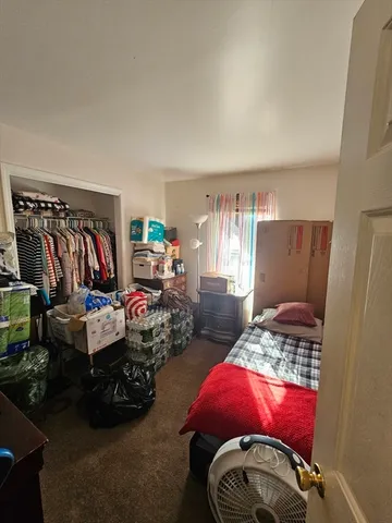 a bedroom with two beds and a window