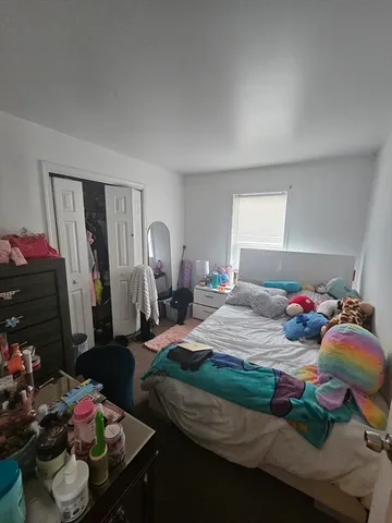 a bedroom with bed and a window