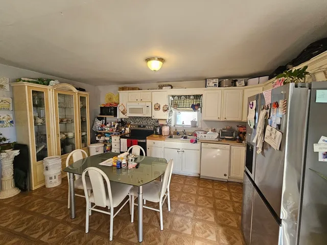a kitchen with refrigerator and cabinets