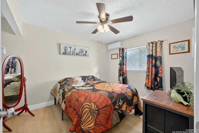 a bedroom with bed and a chandelier