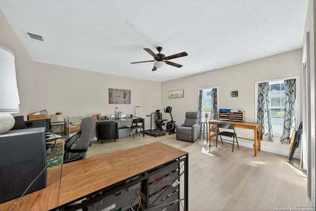 a living room with furniture kitchen view and a window