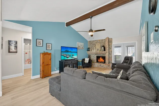 a living room with furniture a fireplace and a flat screen tv