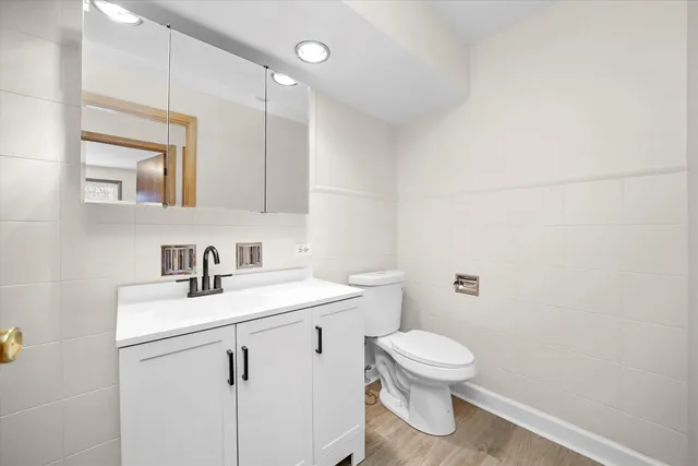 a bathroom with a toilet a sink and mirror