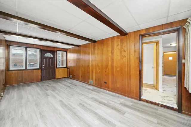an empty room with wooden floor and sliding door