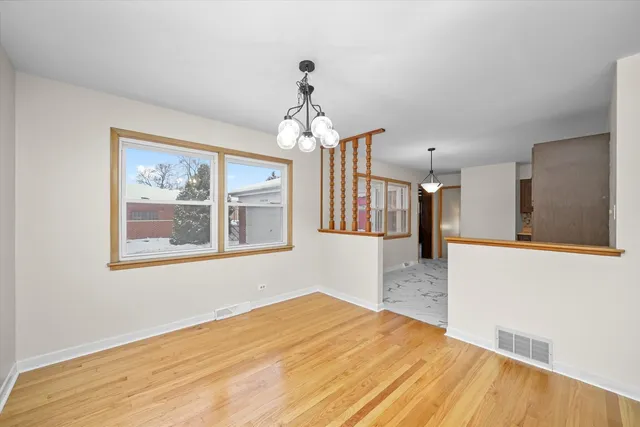 a very nice looking room with wooden floor and a large window