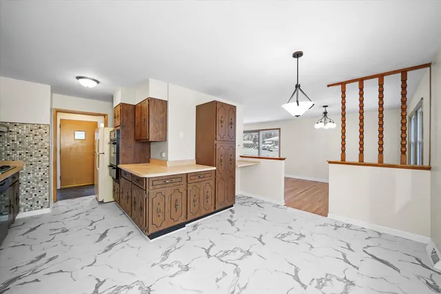 a spacious bathroom with a tub sink and mirror