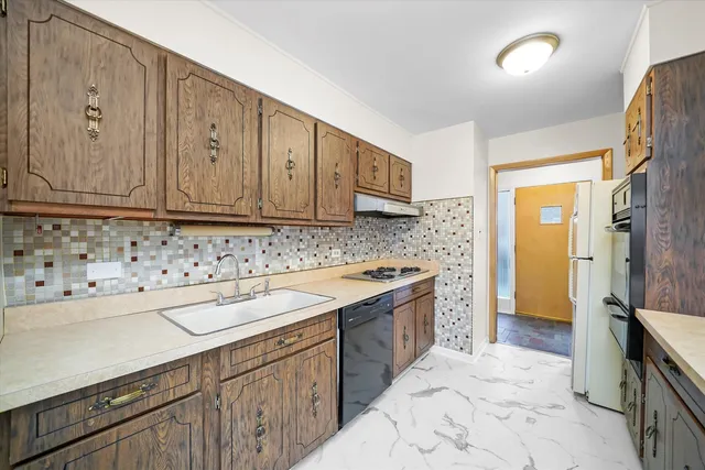 a kitchen with a sink stove and cabinets