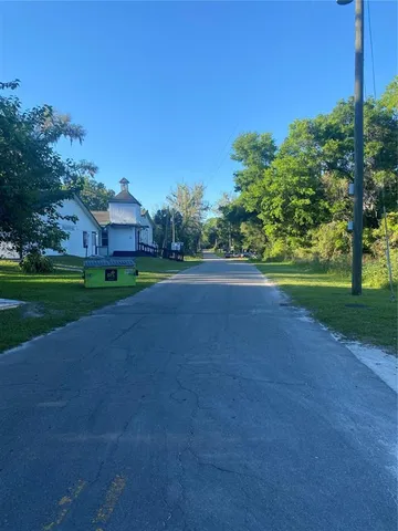 a view of a field of grass and trees