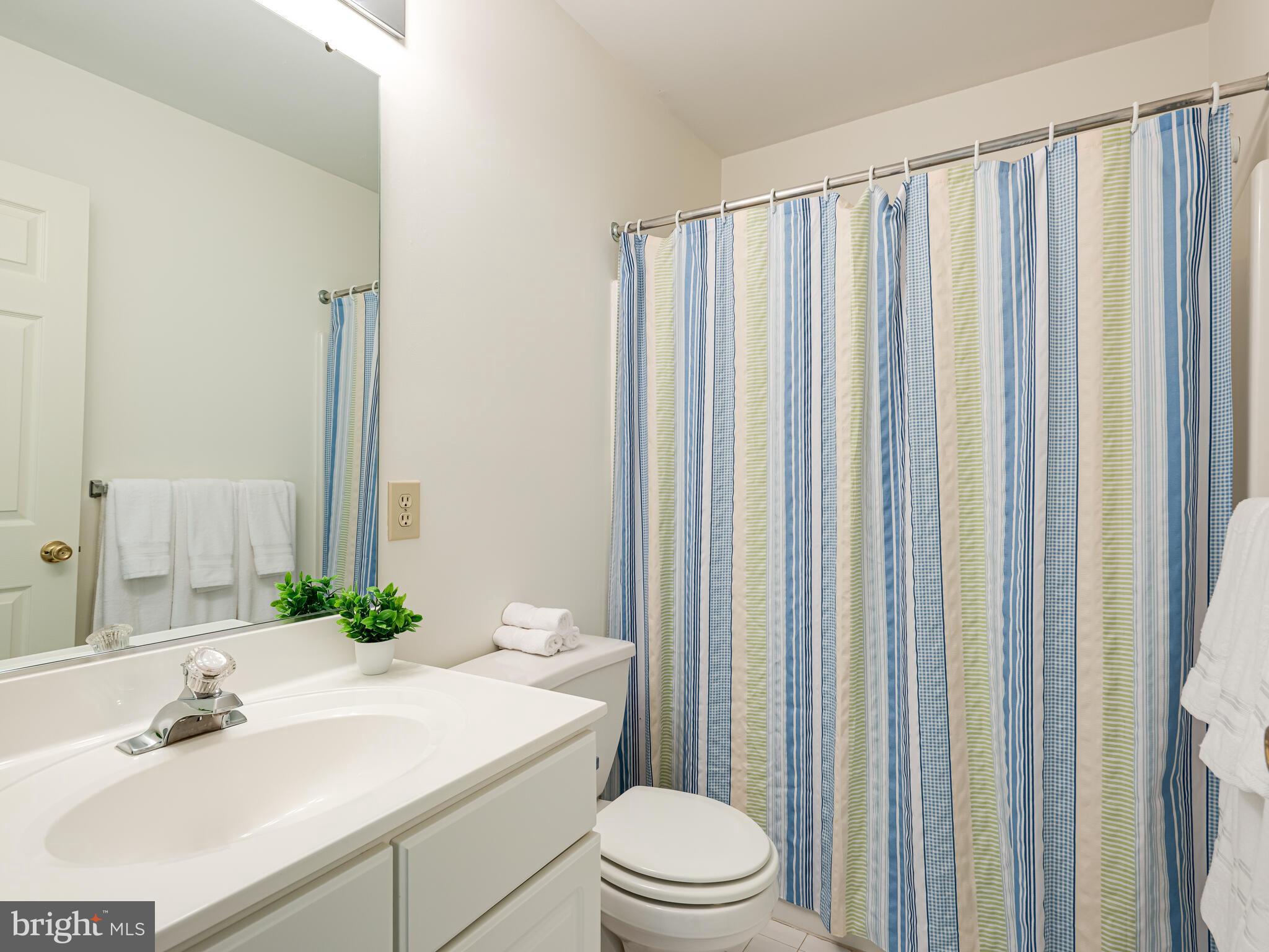 913 Harbour Ridge Lane Downingtown, PA 19335 - Photo 24 of 33 a bathroom with a sink a toilet and shower curtain
