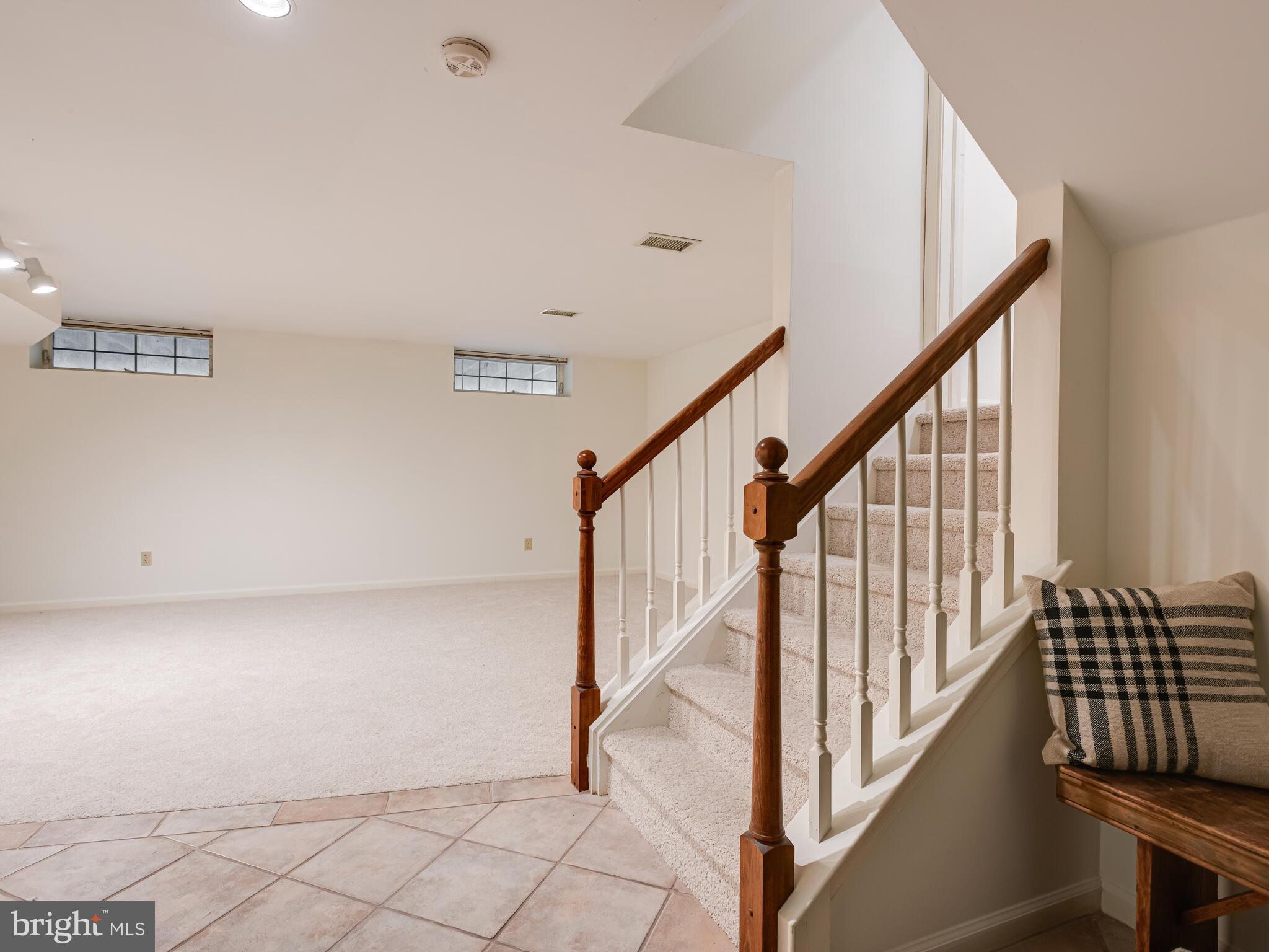 913 Harbour Ridge Lane Downingtown, PA 19335 - Photo 29 of 33 a view of staircase with lots of frames on wall and a window