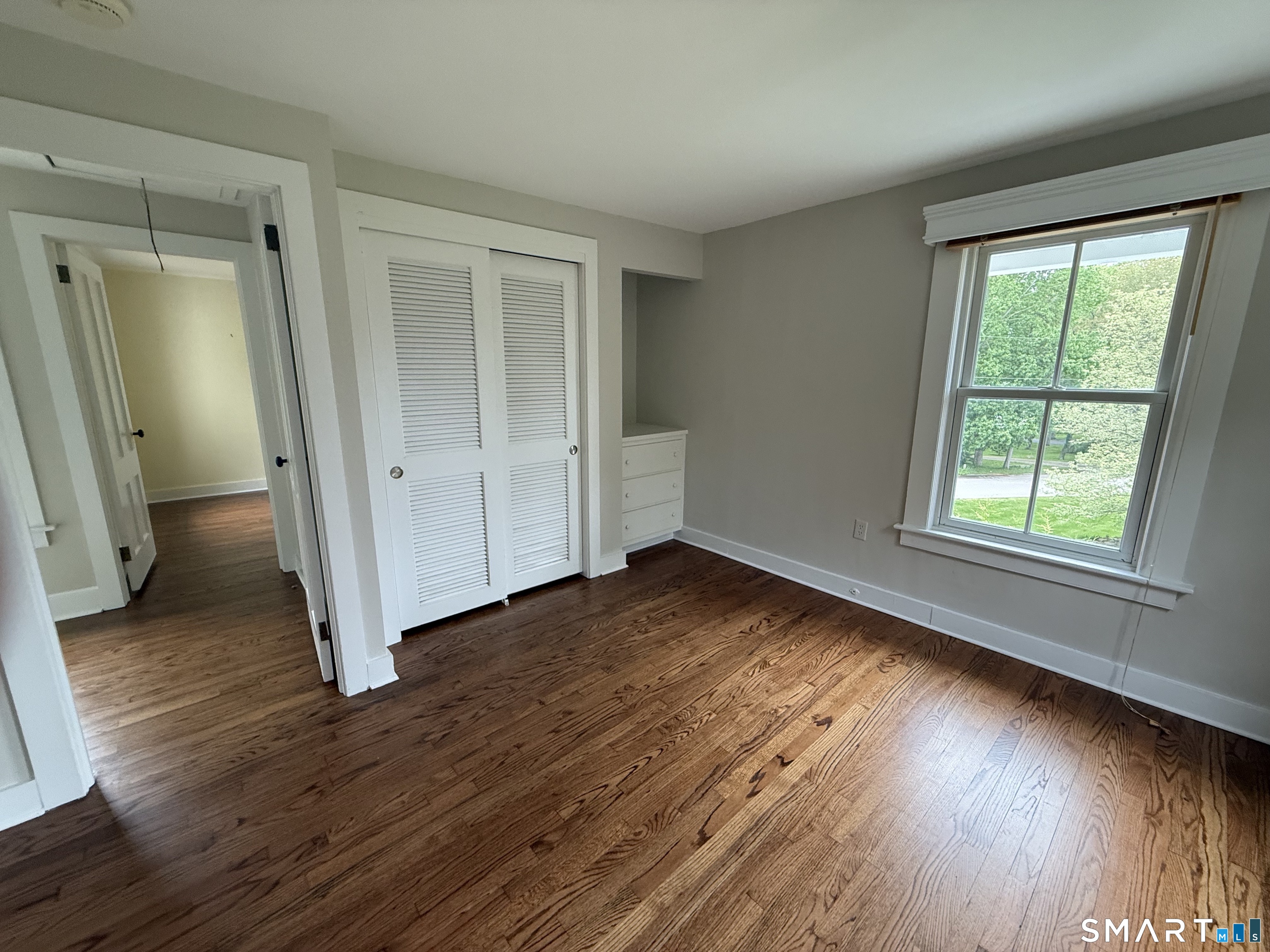 312 Ferry Road Old Lyme, CT 06371 - Photo 15 of 16 an empty room with wooden floor and windows